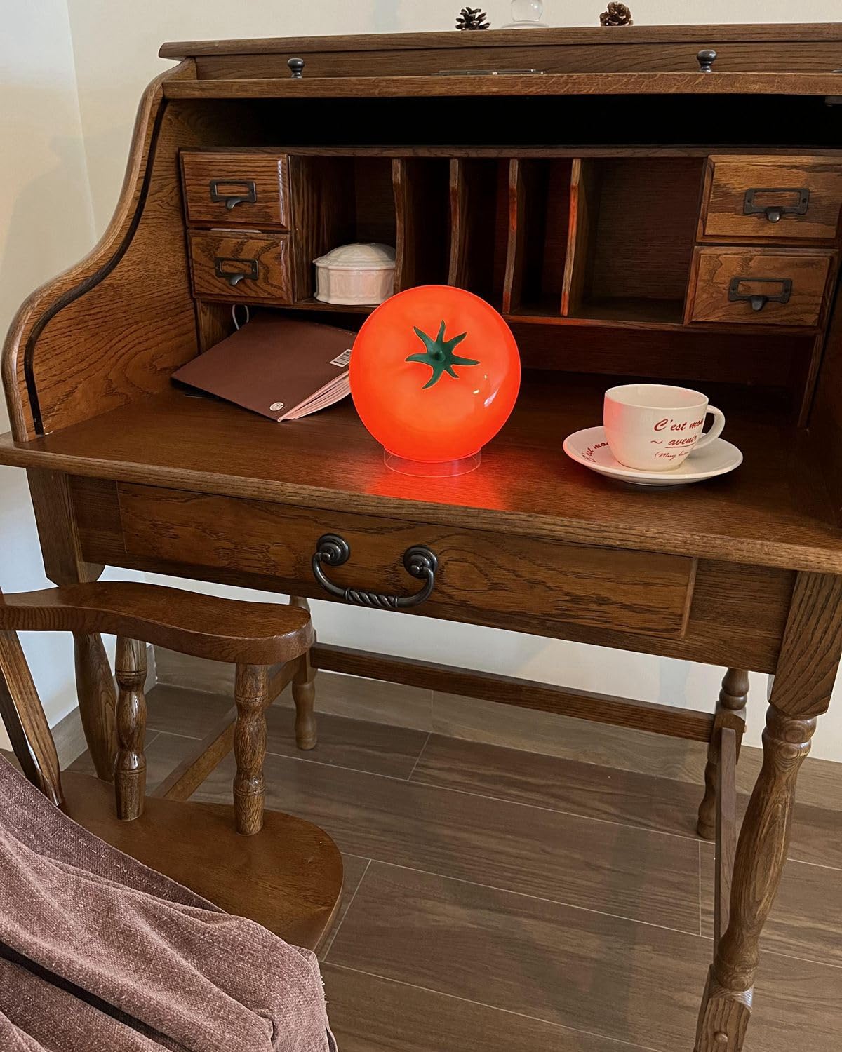 Cozifycasa Fruit decor lamp emits red orange glow for cozy dining ambiance.