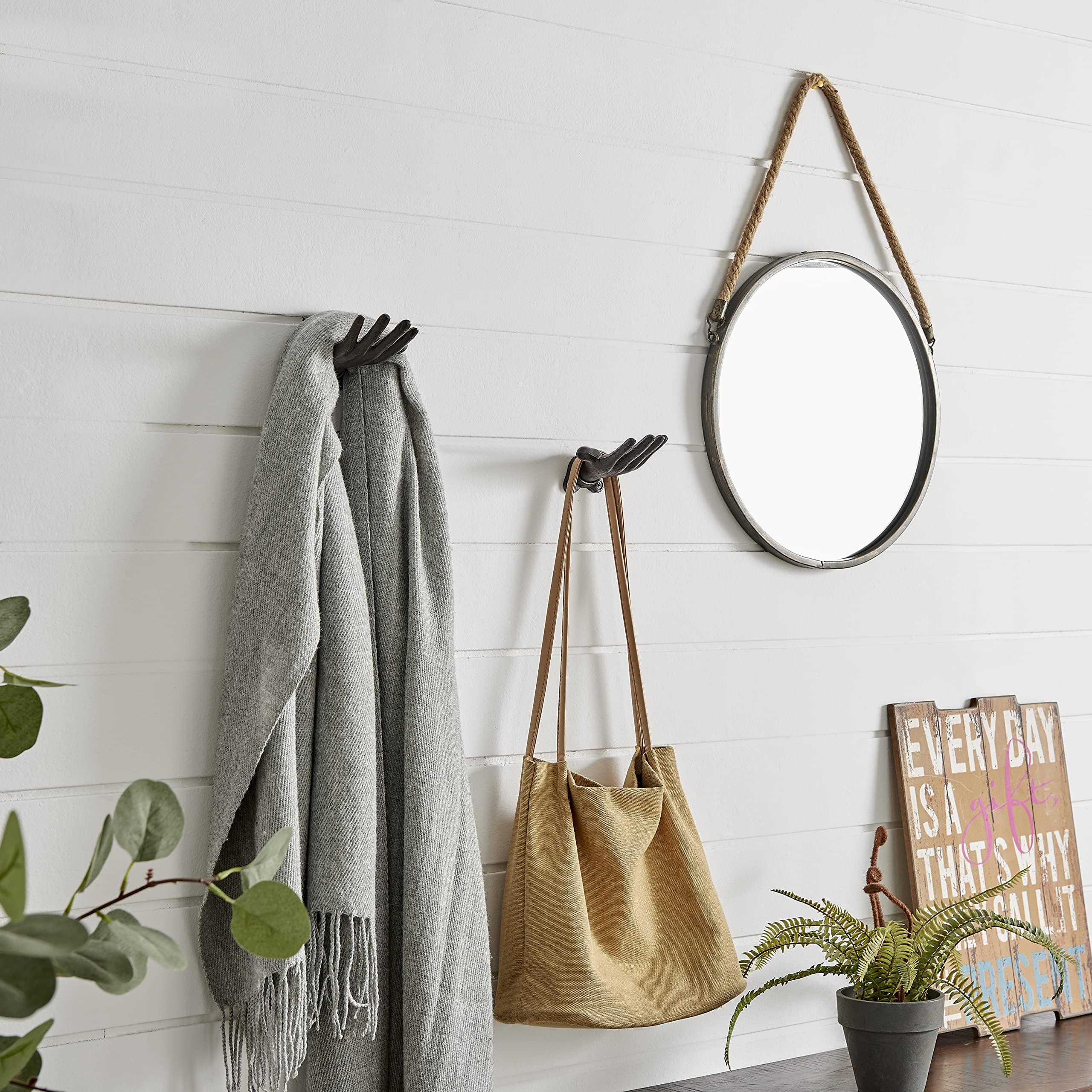 Danya B Palms Up enhances bathroom decor while holding towels or robes.