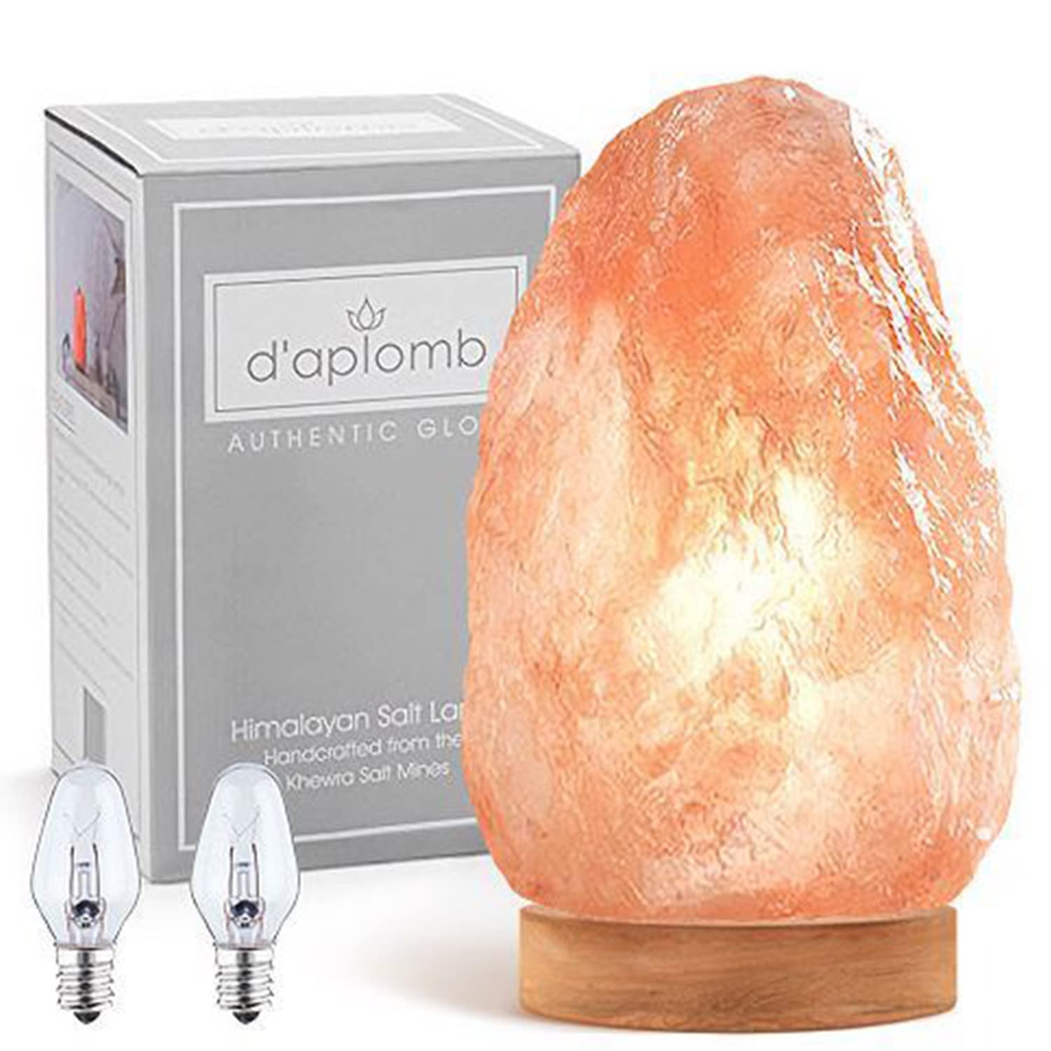 daplomb Himalayan salt lamp on a carved wood base emitting a warm, calming glow.