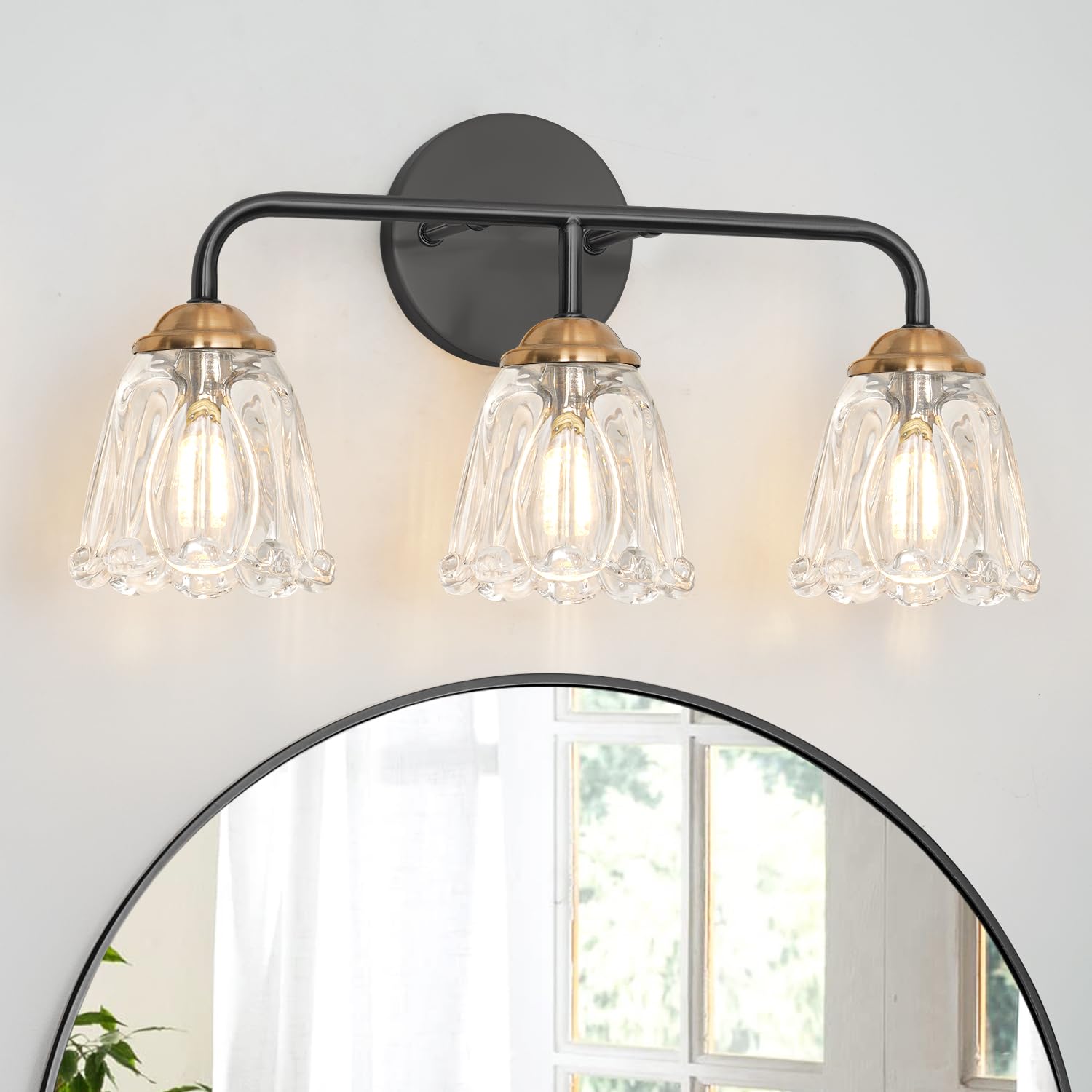 Daunton vintage 3-light vanity light with brushed brass and clear glass shades enhances bathroom ambiance