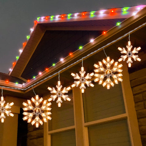 Dazzle Bright snowflake lights shown along a home exterior for holiday ambience.