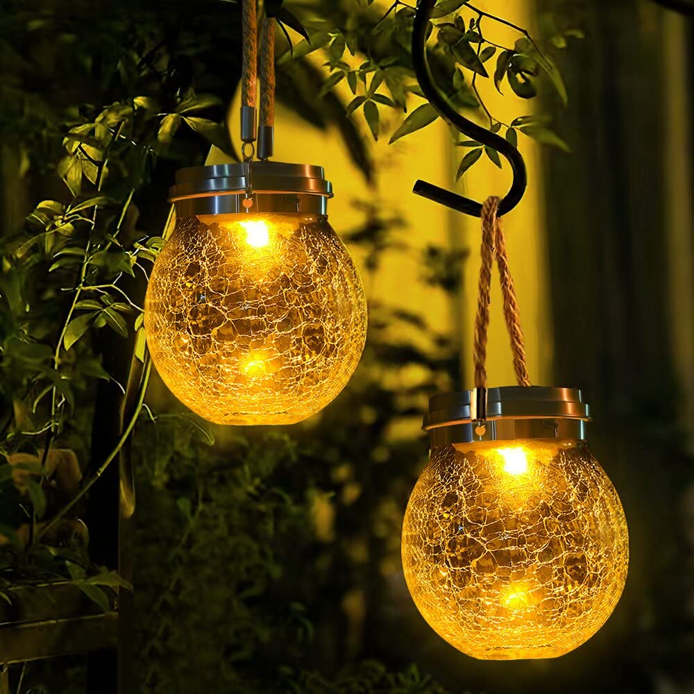 DBF solar lantern with crackle glass ball emits amber warm glow for outdoor spaces.
