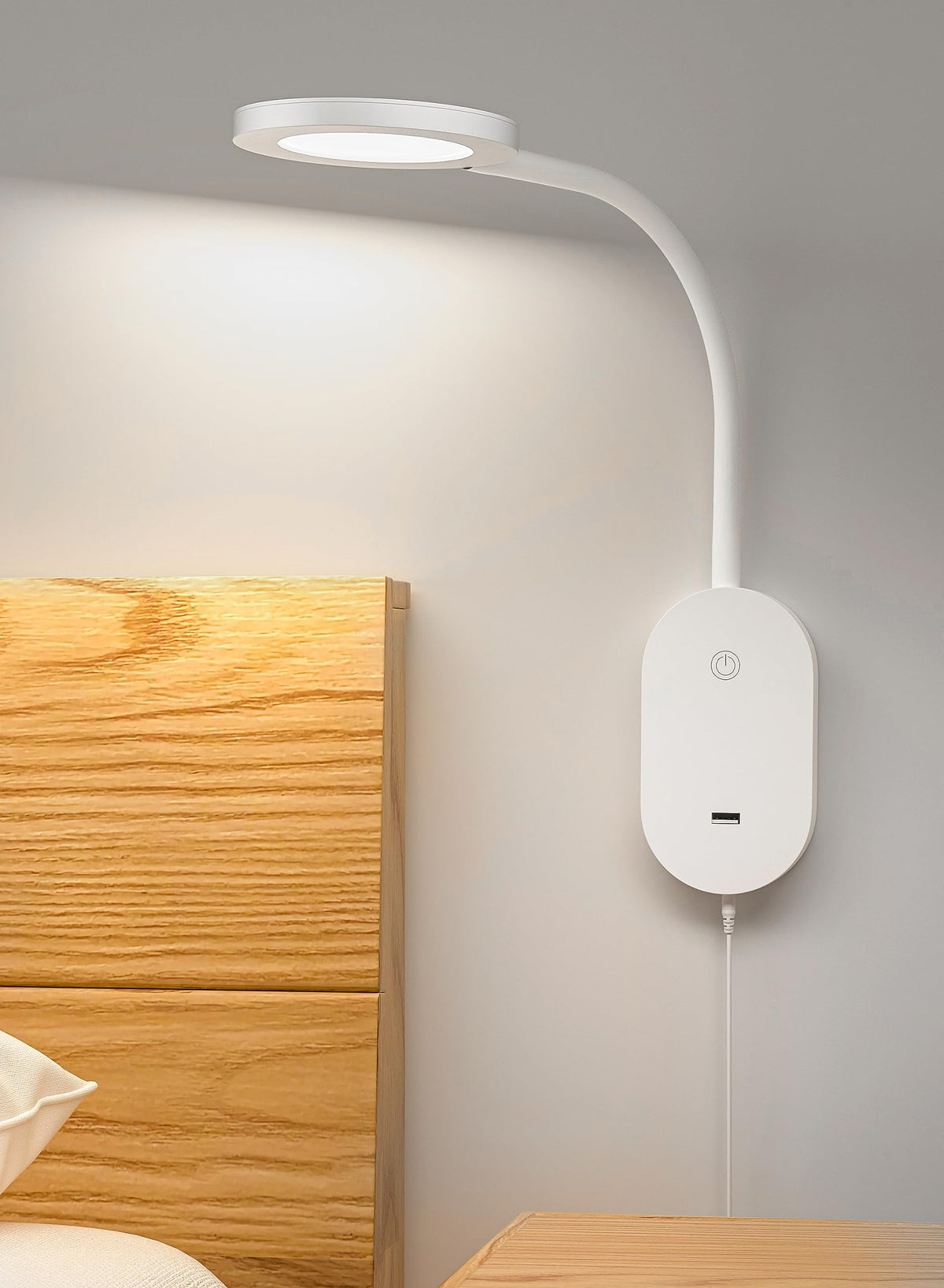 Deeloop wall-mounted reading light with USB output for convenient bedside charging.
