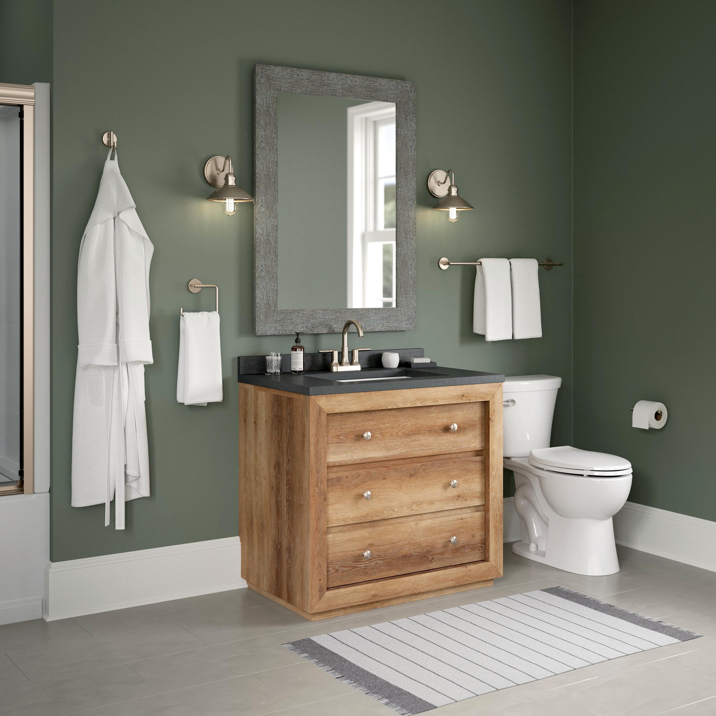 Front view of Delta Trinsic toilet paper holder, sleek stainless steel finish.