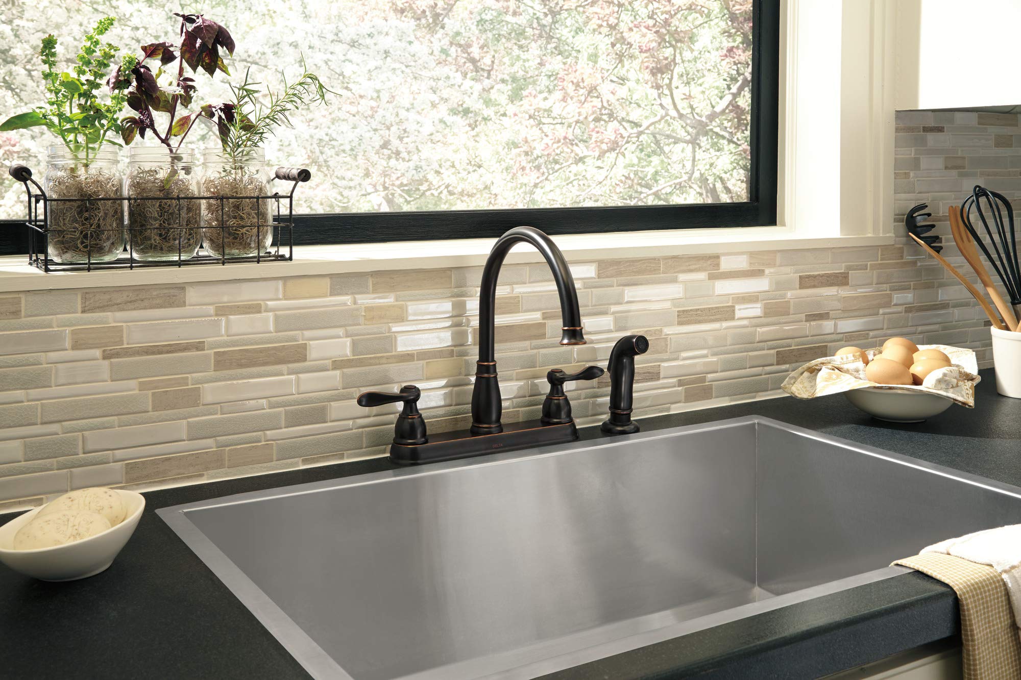 Delta Windemere faucet side sprayer attachment demonstrates versatile cleaning.