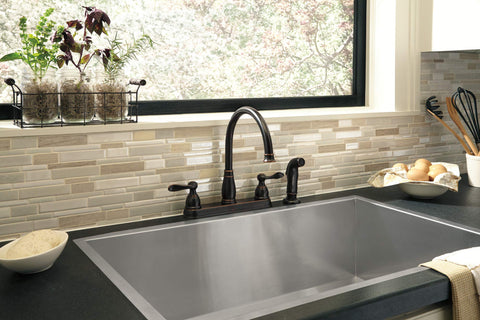 Delta Windemere faucet side sprayer attachment demonstrates versatile cleaning.