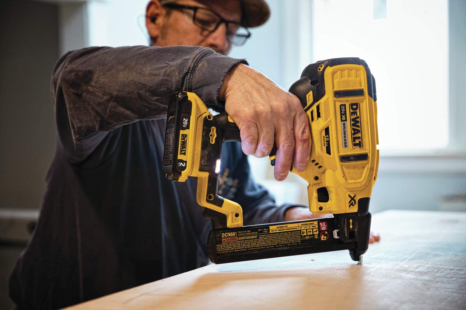 DEWALT DCN681B cabinetry application image showing precise staple placement.