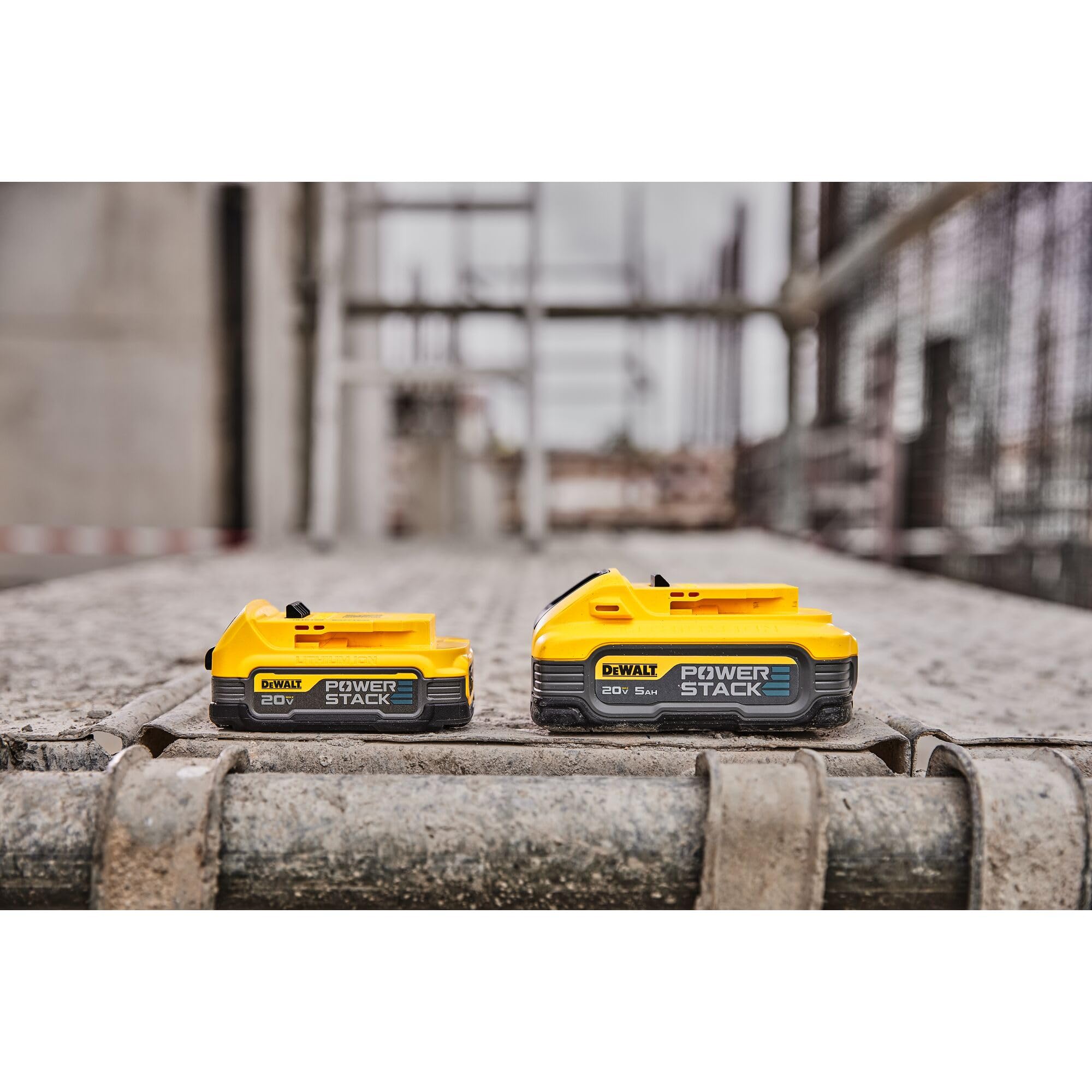 DEWALT PowerSTACK 5Ah battery in use on a busy worksite emphasizing extended runtime