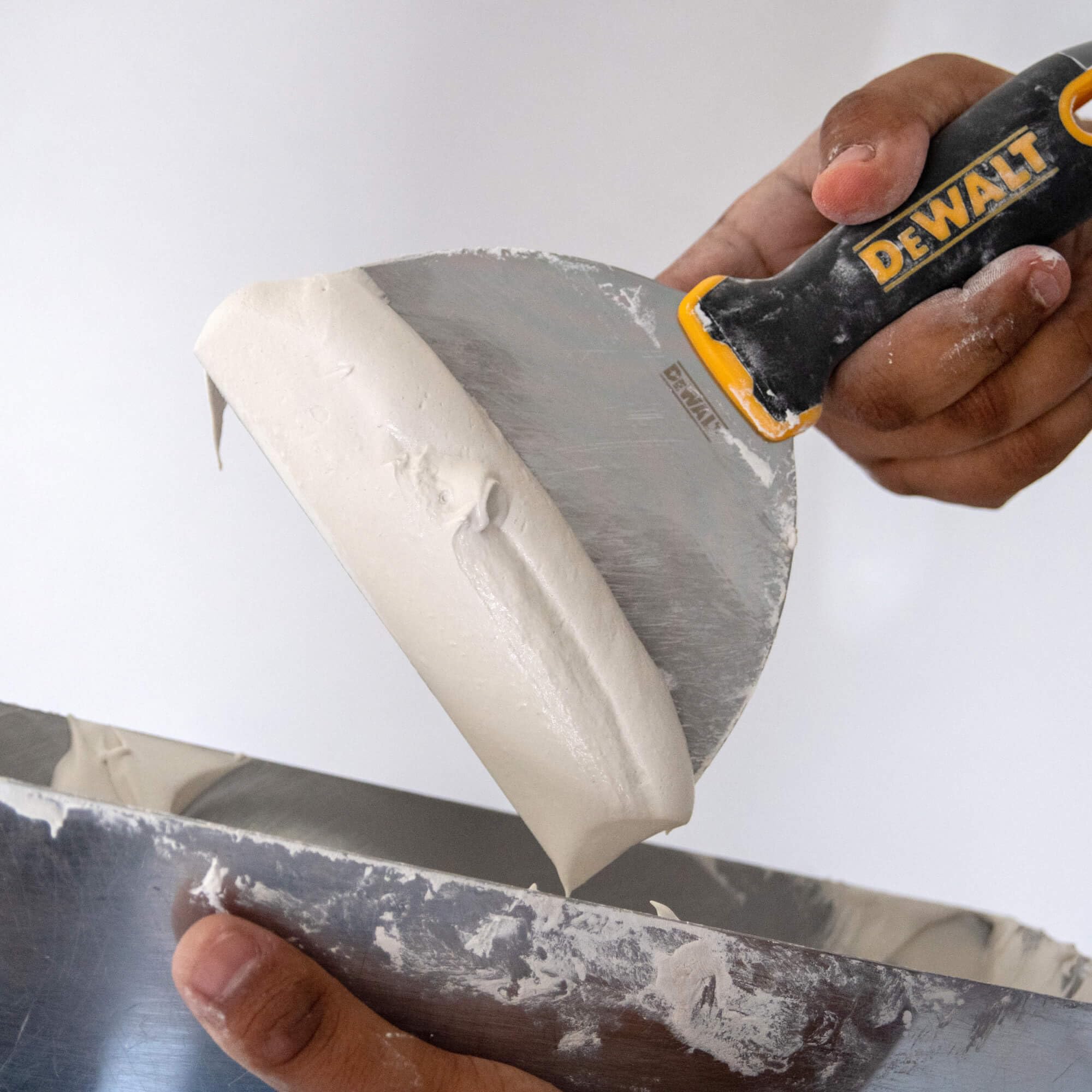 DEWALT putty knife double riveted handle for secure, durable use.