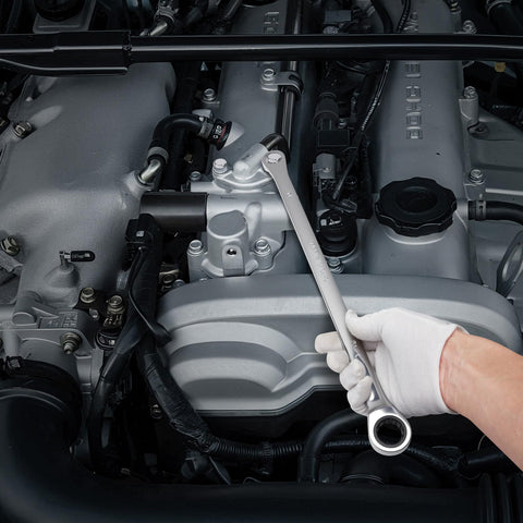 DISEN wrench set in use on car engine for efficient repairs.