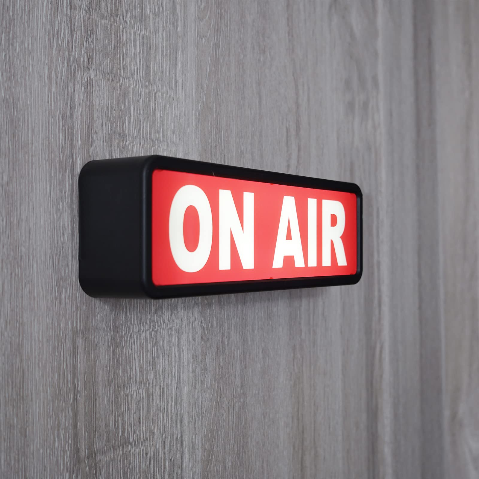 DMKYDM ON AIR light sign in studio use with vibrant color glow