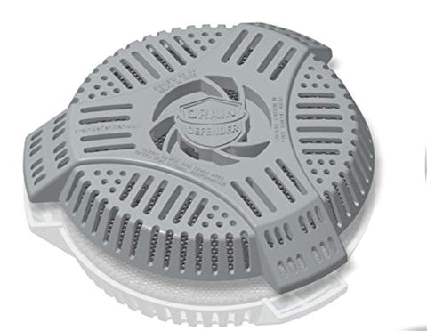 Drain Defender two-stage cover over a round drain blocks yard debris.