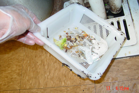 Durable Drain-Net floor sink basket in a commercial kitchen with high-temperature tolerance.