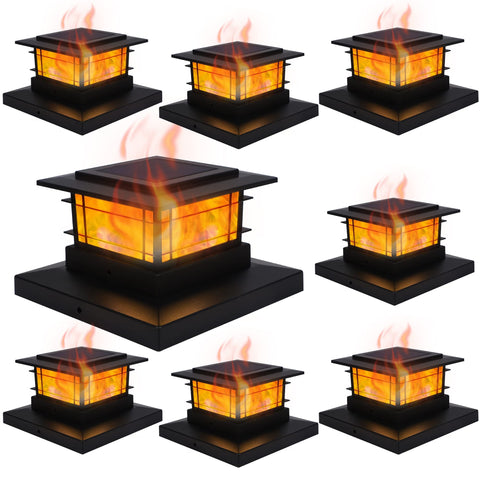 Dynaming solar post cap light with flickering flame illuminates wooden posts at dusk.