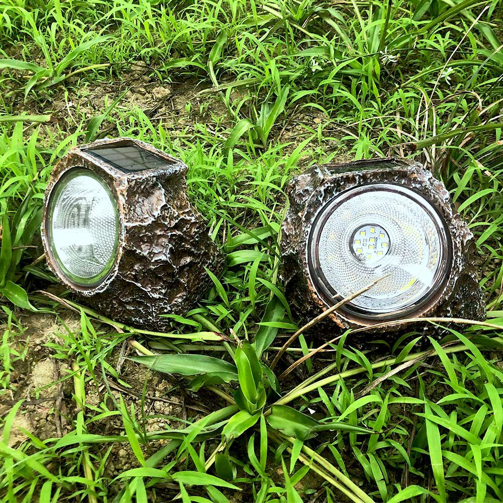 Weatherproof rock light adds decorative glow to lawn and path.