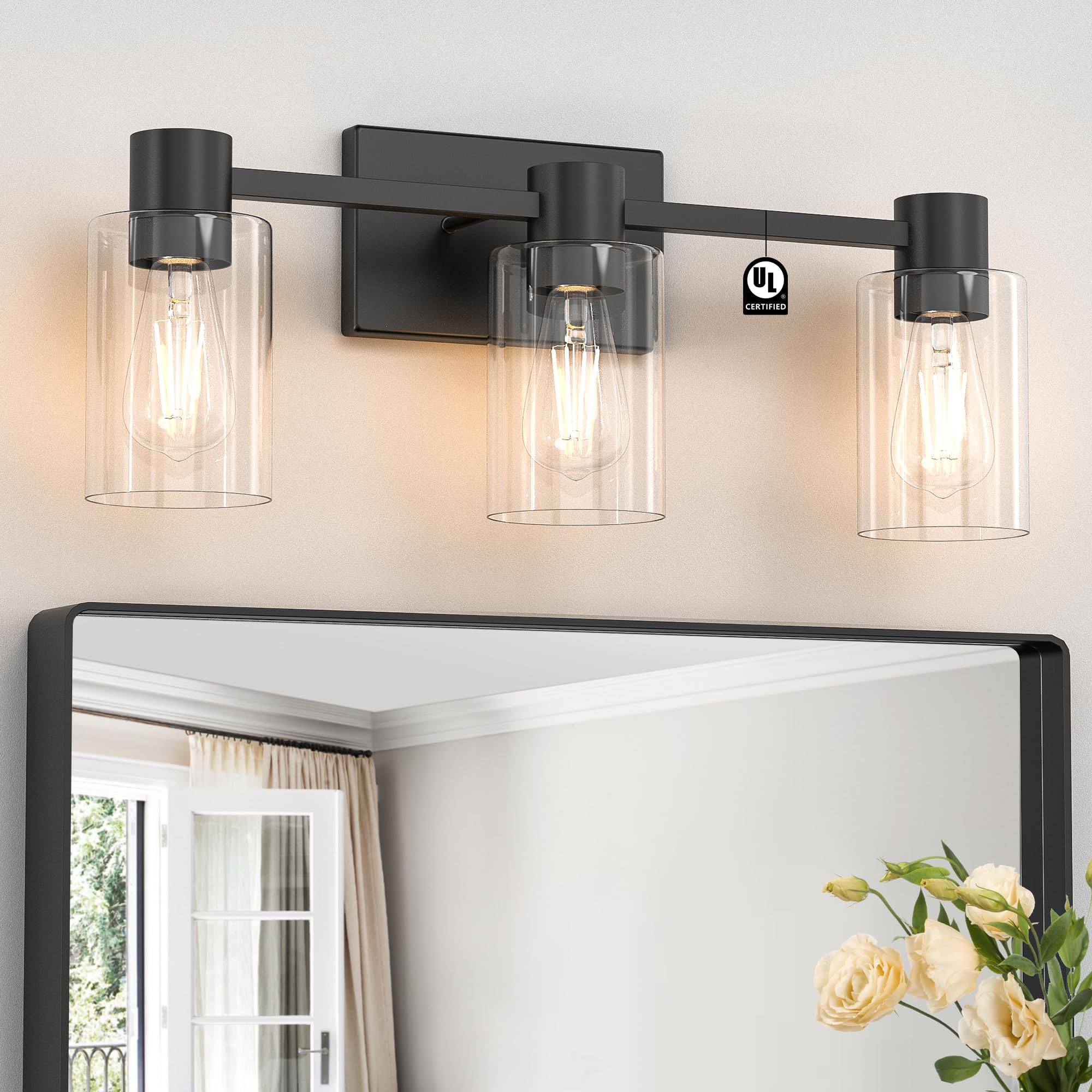 Esfos 3-light matte black wall sconce with a clear glass shade for bright bathroom illumination.