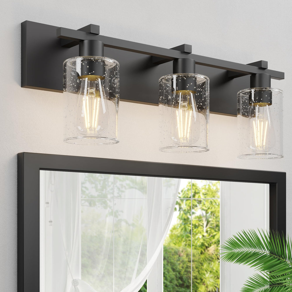 Espird three-light vanity light with seeded glass brightens the bathroom mirror