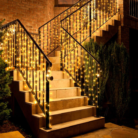 Eueasy curtain lights outdoor create waterfall glow on balcony for cozy evenings.