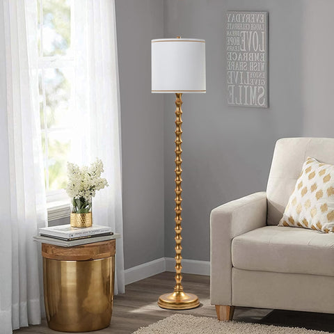 EUO tall floor lamp in living room creates warm, inviting ambiance