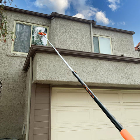 EXTEND-A-REACH cobweb duster attachment in use for ceiling corners.