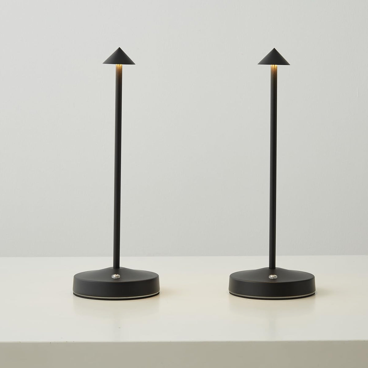 eypid 2-pack cordless lamps black on table for warm ambient lighting.