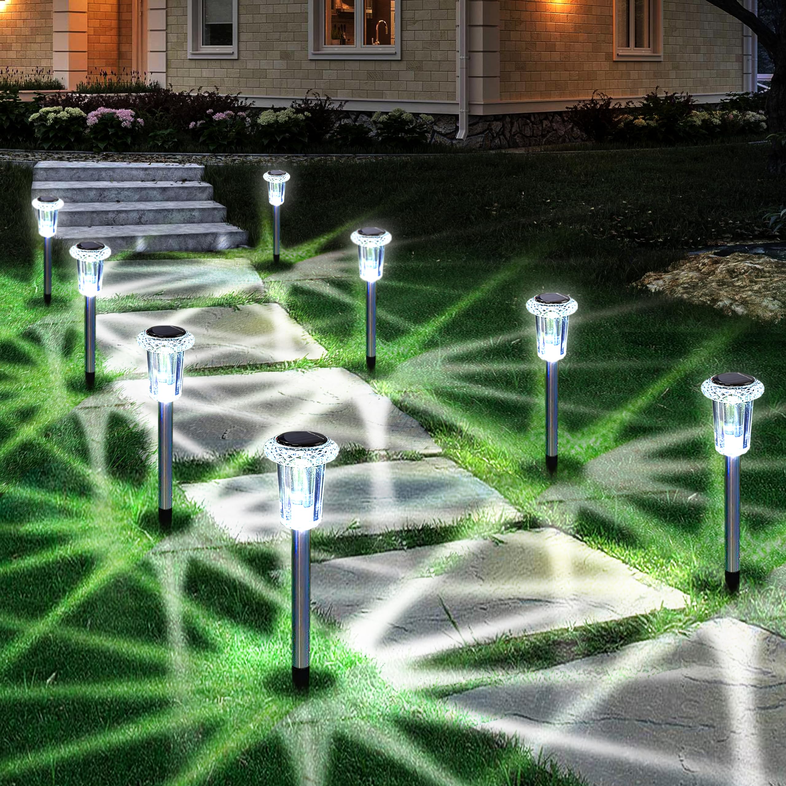 Eyrosa solar stake lights illuminate a stone pathway with bright cool white light.