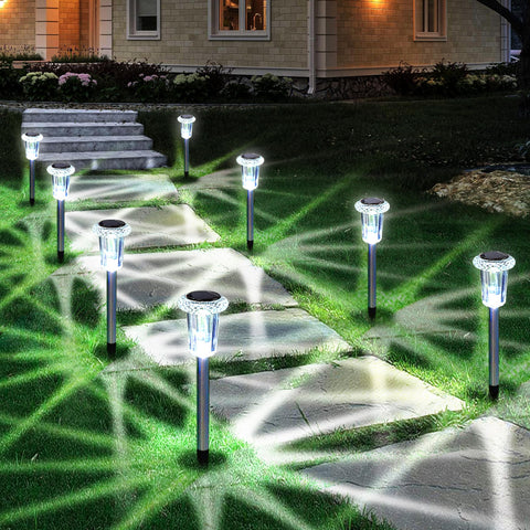 Eyrosa solar stake lights illuminate a stone pathway with bright cool white light.