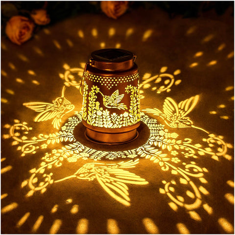EZTZEN hummingbird solar lantern hanging in garden with warm LED glow.