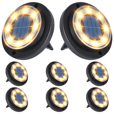 Flacchi solar ground light disk on ground providing even warm illumination along a path.