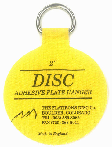 Flatirons Disc adhesive plate hangers on wall show clean display without hooks.