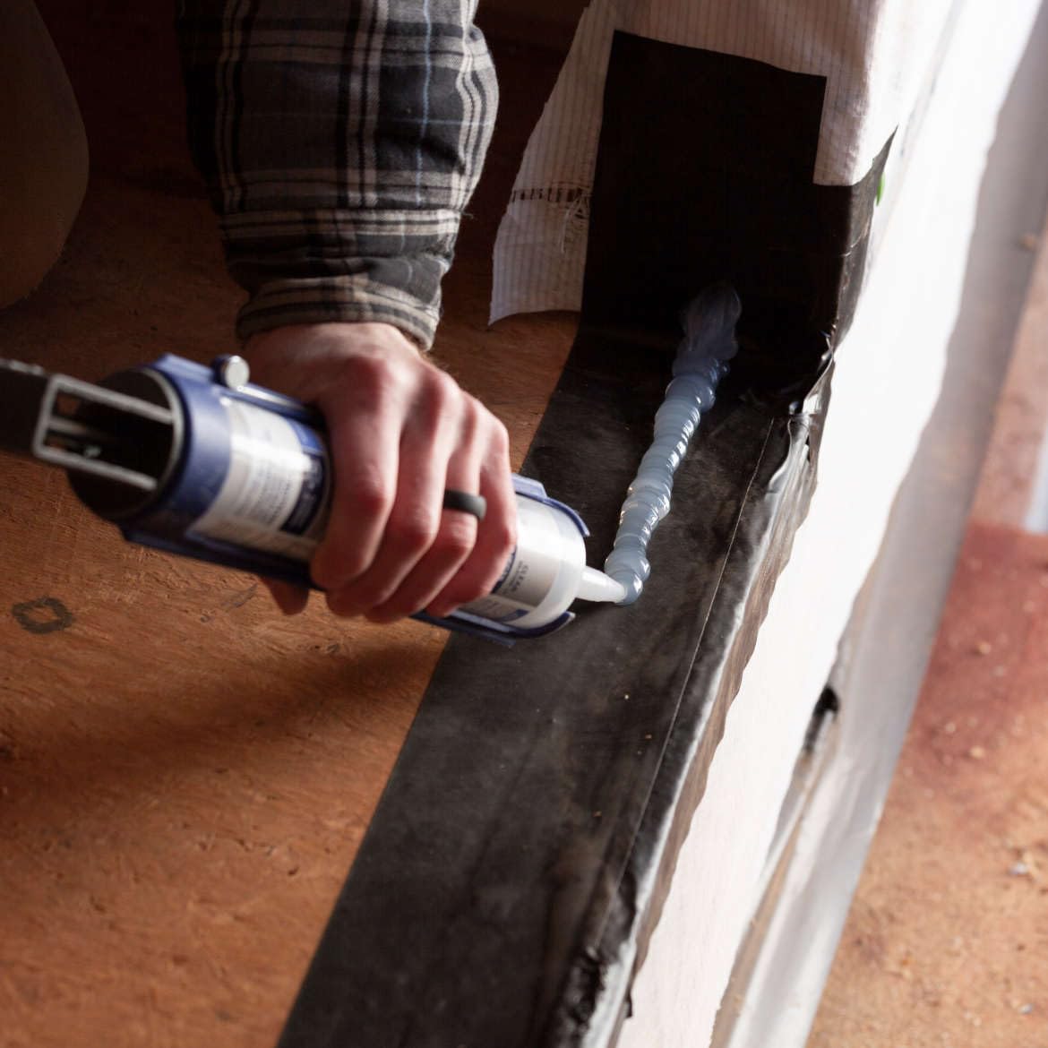 Sunlit exterior seam shows FrogTape Pro Grade UV resistance for outdoor use.