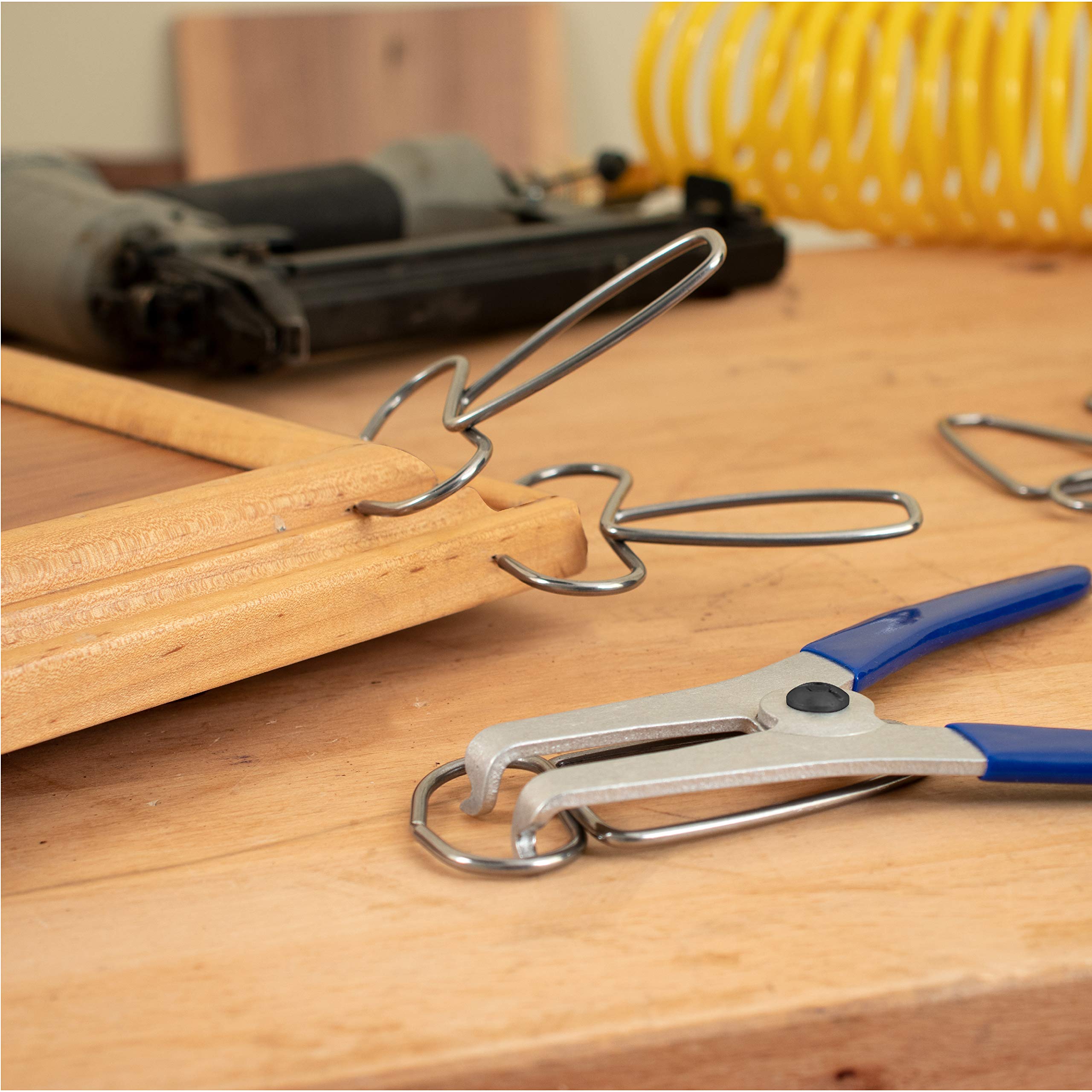 Side view of Fulton Miter Spring Clamps on a wooden frame.