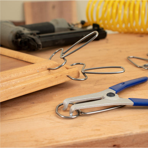 Side view of Fulton Miter Spring Clamps on a wooden frame.