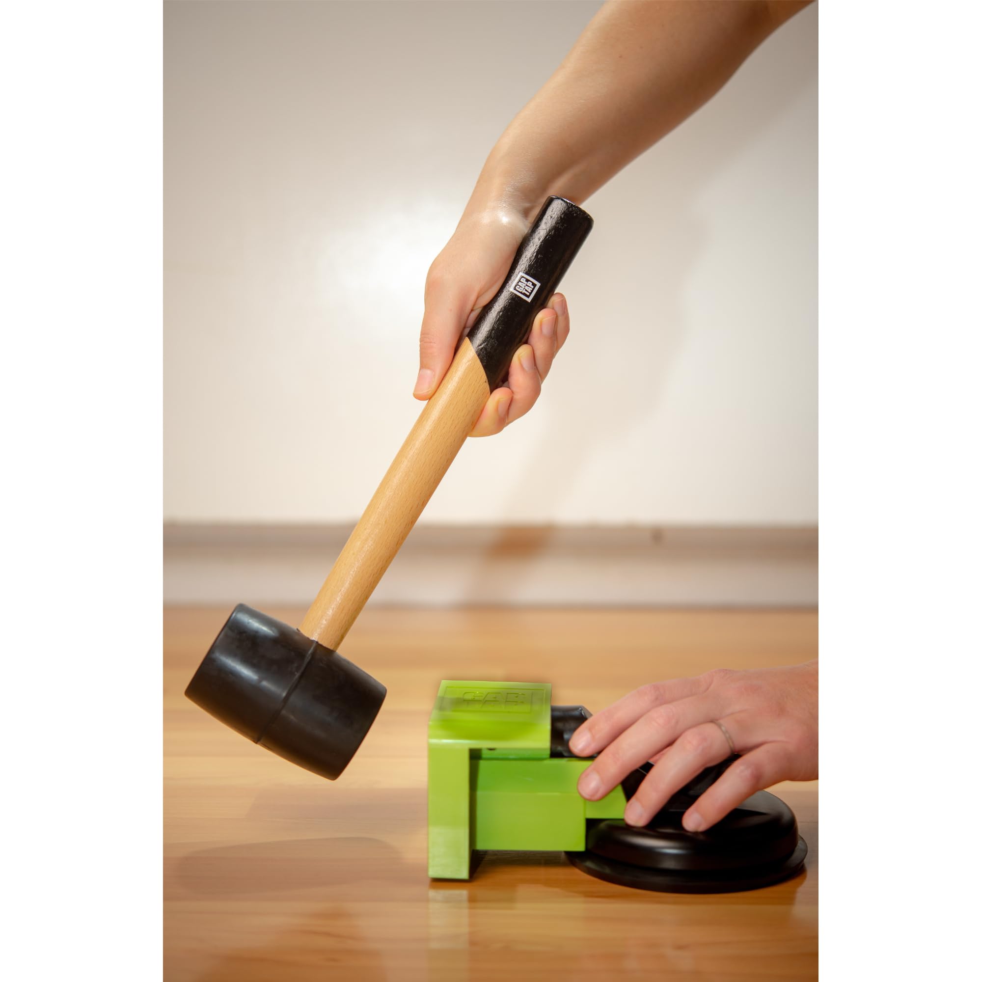 Gap Tap heavy-duty tool with suction cup demonstrating firm grip on the floor