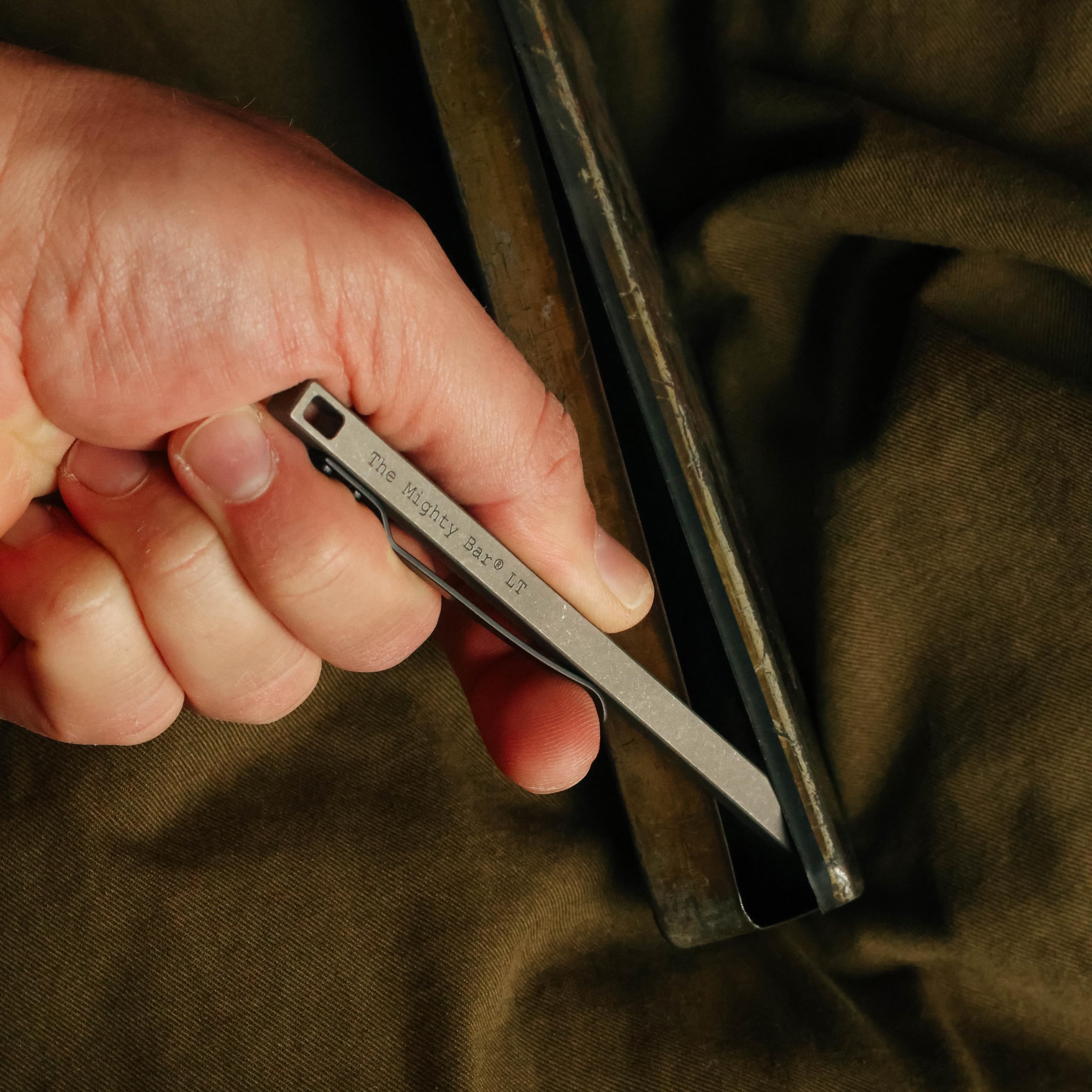 Gear Spool Mighty Bar LT pocket clip shown securing carry on gear