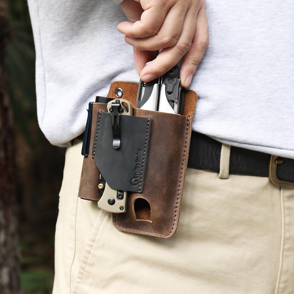 Gentlestache leather multitool sheath on belt demonstrates secure clip for everyday carry.