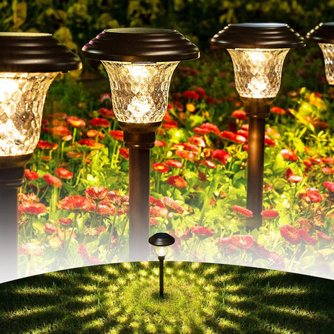 GIGALUMI 8-pack solar pathway lights along a stone path providing warm white illumination.