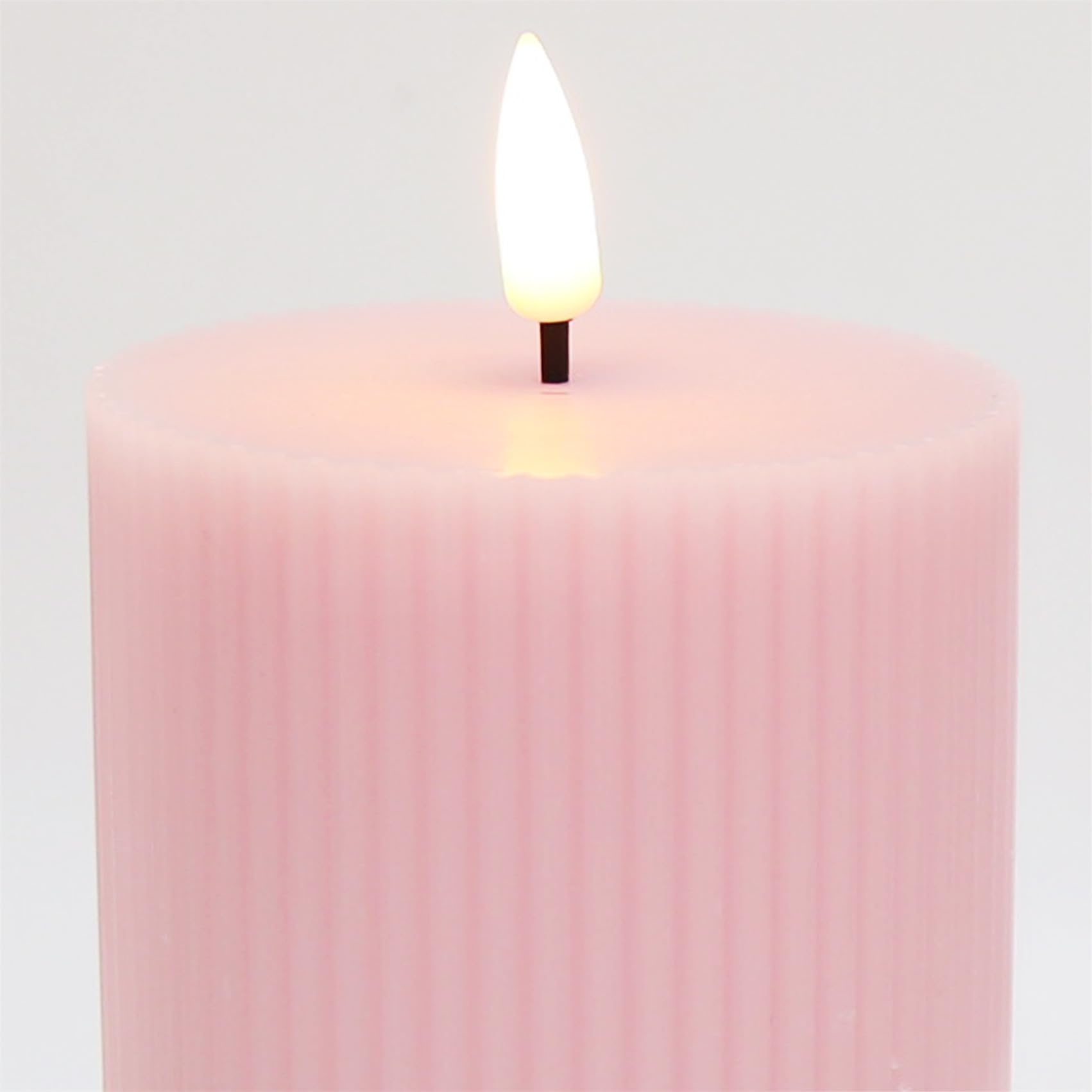 Girimax pink ribbed LED pillar candle smokeless and dripless for safe homes.