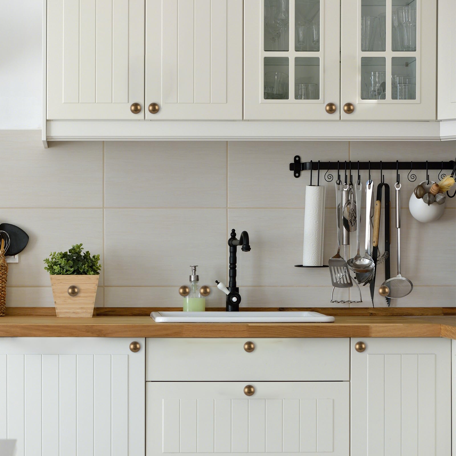 GIYURO antique brass cabinet knobs mounted on a cabinet panel