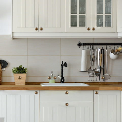 GIYURO antique brass cabinet knobs mounted on a cabinet panel
