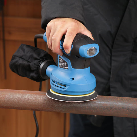 G LAXIA Orbital Sander in use on a wooden surface for a smooth finish.