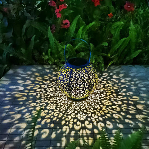 Go2garden teal blue solar outdoor lantern glowing softly on patio at dusk for ambiance.