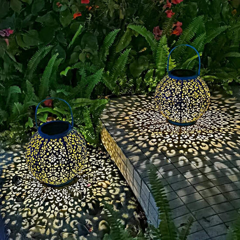 Go2garden decorative pattern on teal lantern enhances yard aesthetics.