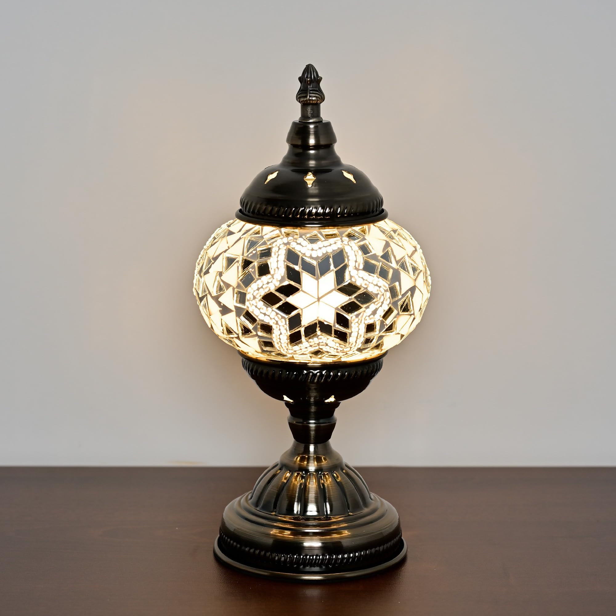 GOGERS lamp lit with warm glow in a cozy bedroom setting