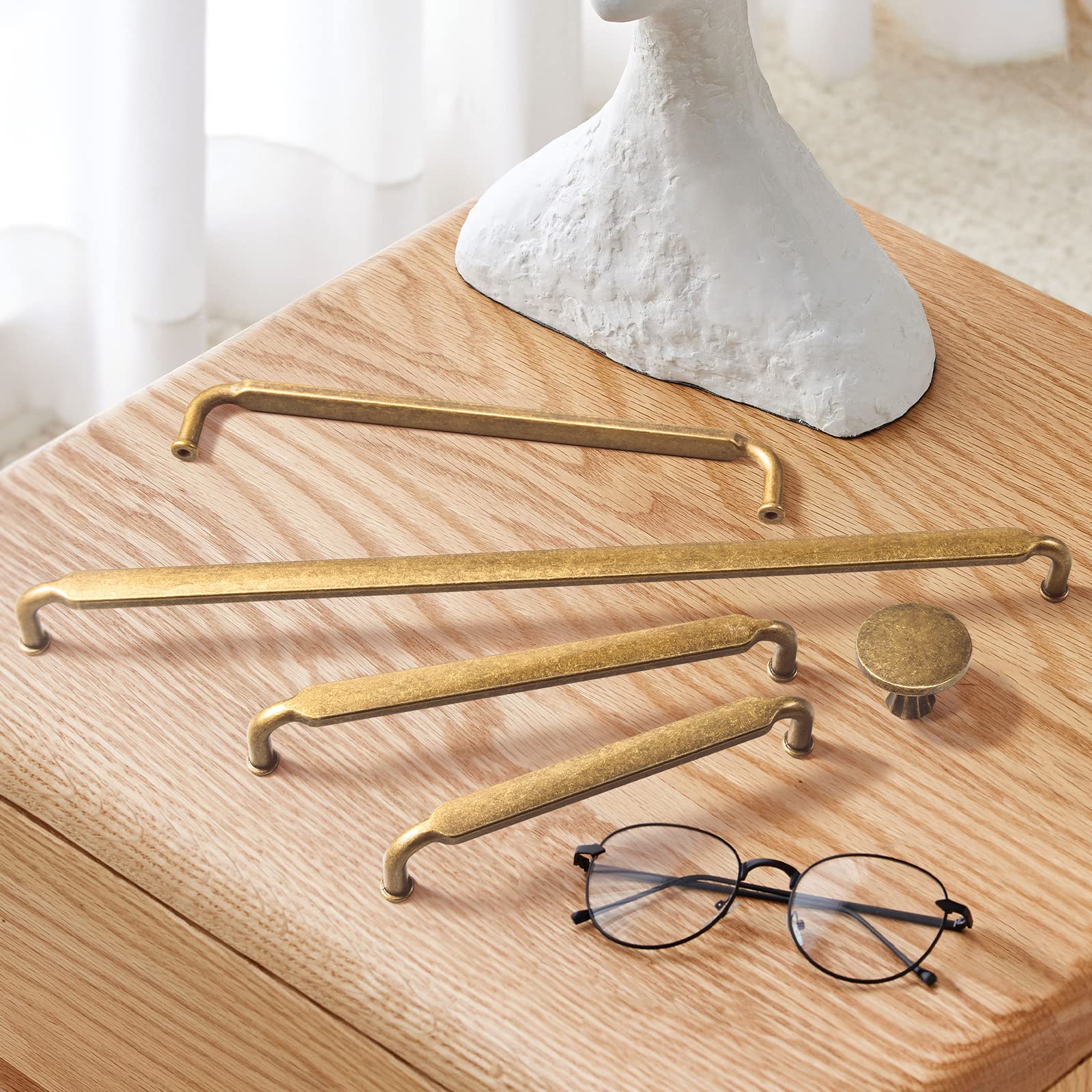 Goo-Ki kitchen cabinet hardware in antique brass adds vintage charm.