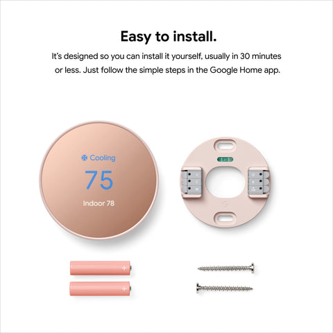 Google Nest Thermostat installed on a wall in a modern living room.