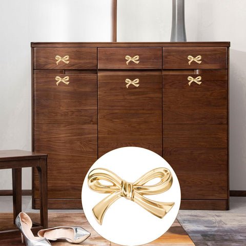 Gosknor bedroom bow knob complements dressers with antique-inspired shine