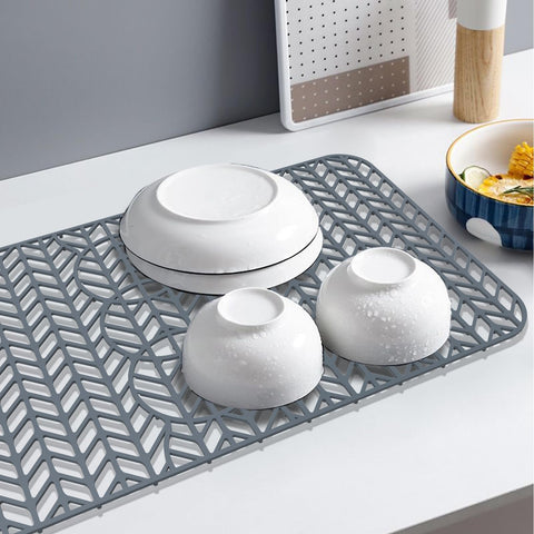 GUUKIN elevated grid mat promotes water flow toward the drain.