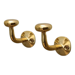 HANDLUX unlacquered brass wall hook holding coats with vintage charm
