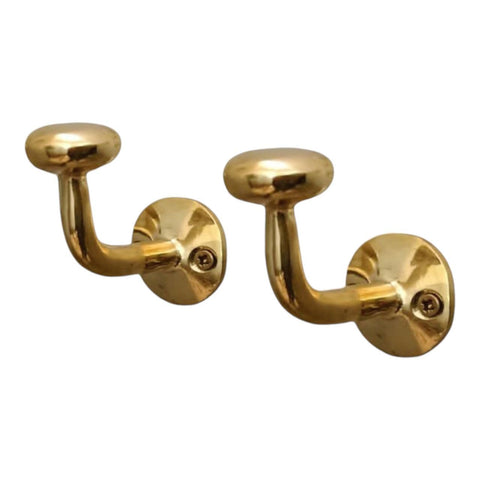 HANDLUX unlacquered brass wall hook holding coats with vintage charm